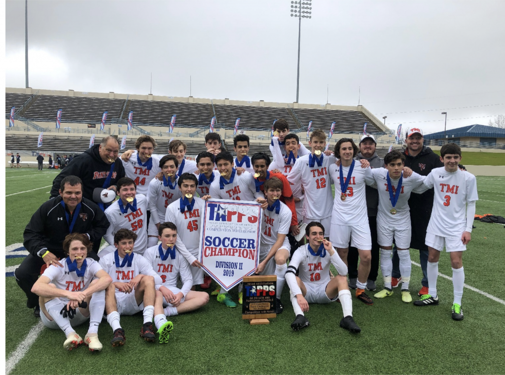 Photo of The TMI boys varsity soccer team celebrating their state championship on Feb. 22 in Waco.