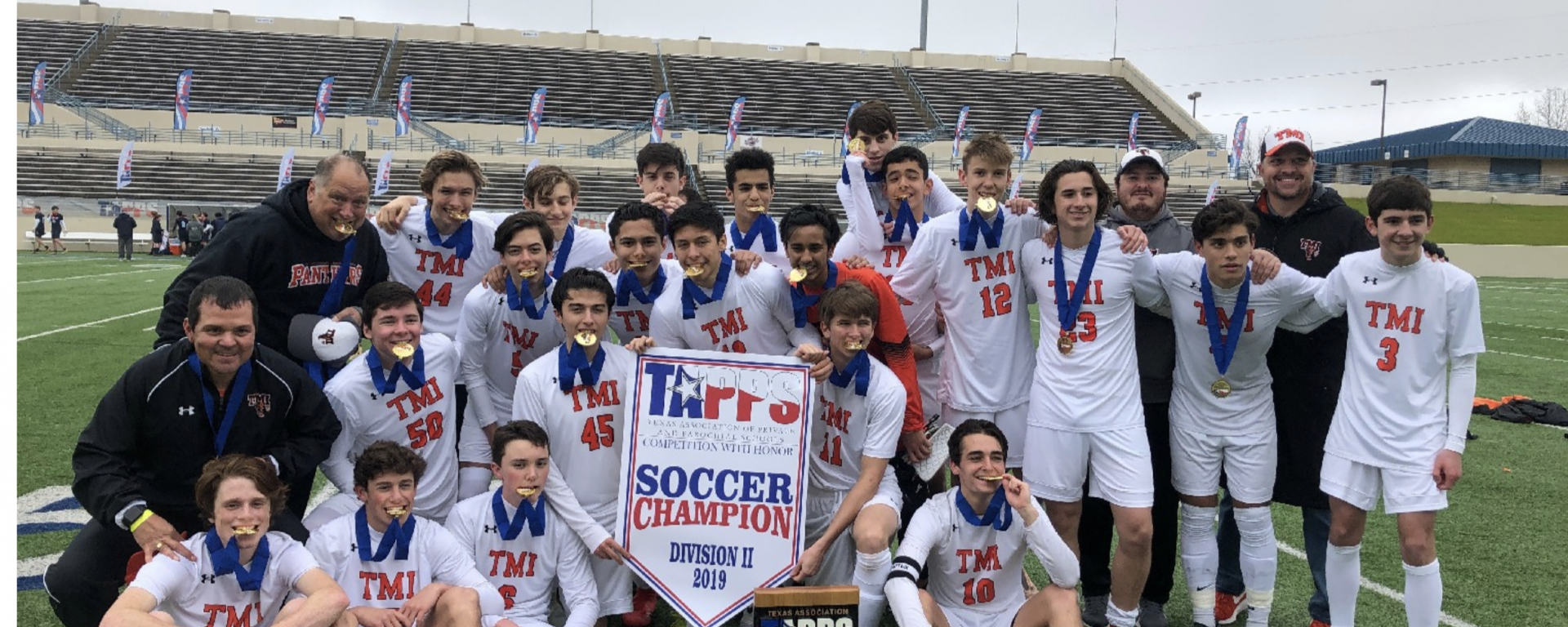Photo of The TMI boys varsity soccer team celebrating their state championship on Feb. 22 in Waco.