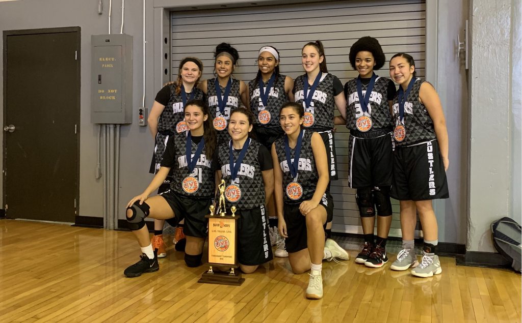 Photo of rising junior and her basketball team winning their division championship