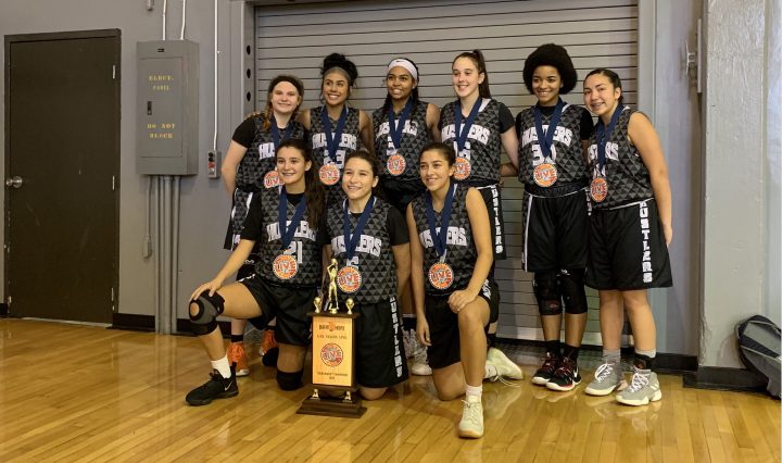 Photo of rising junior and her basketball team winning their division championship